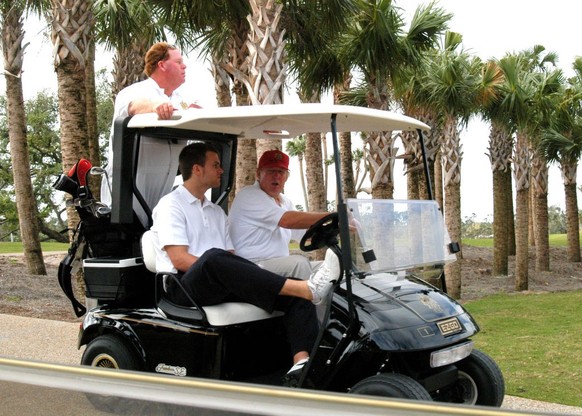 View of American football player Tom Brady (seated left) and real estate developer Donald Trump in a golf cart at Trump International Golf Club, Palm Beach, Florida, January 22, 2006. (Photo by Davido ...