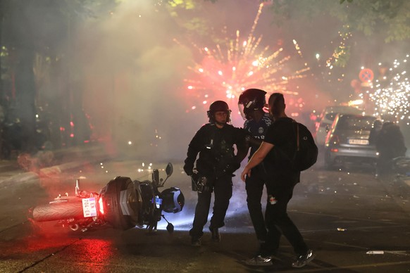 Police try to disperses PSG supporters who left off fireworks as they celebrate in Paris, Saturday, May 30, 2026 after the Champions League final soccer match between Paris Saint-Germain and Arsenal t ...