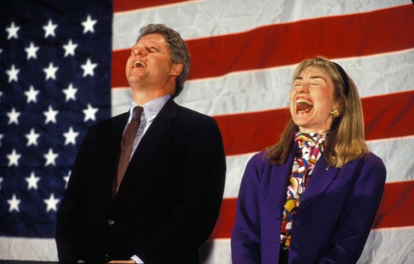 Bill Clinton and Hillary Rodham Clinton laugh as they are about to be introduced at a rally in prior to the New Hampshire primary election. (Photo by Rick Friedman/Corbis via Getty Images)