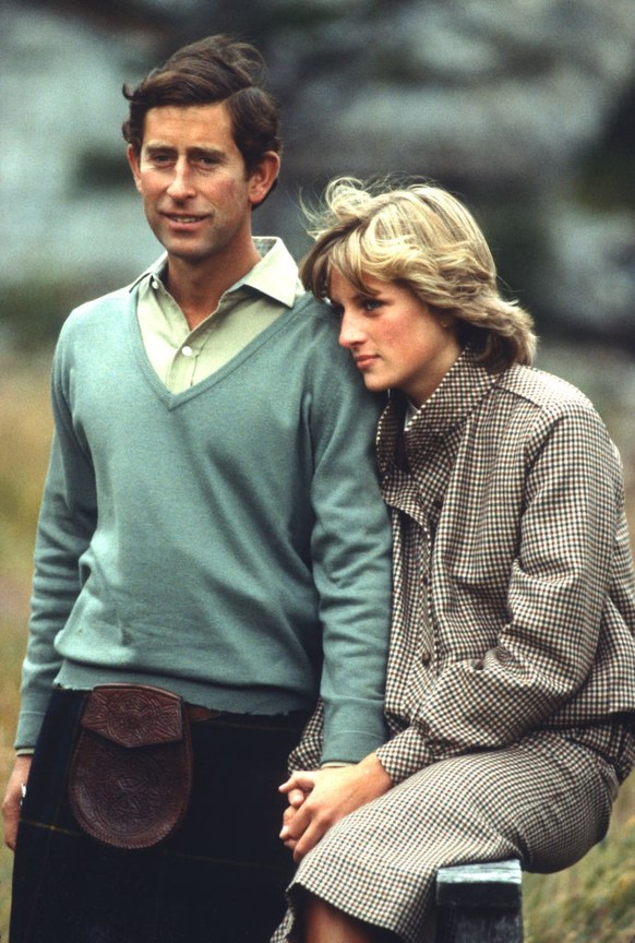 BALMORAL, UNITED KINGDOM - AUGUST 19: Prince Charles, Prince of Wales and Diana, Princess of Wales, wearing a suit designed by Bill Pashley, pose for a photo on the banks of the river Dee in the groun ...