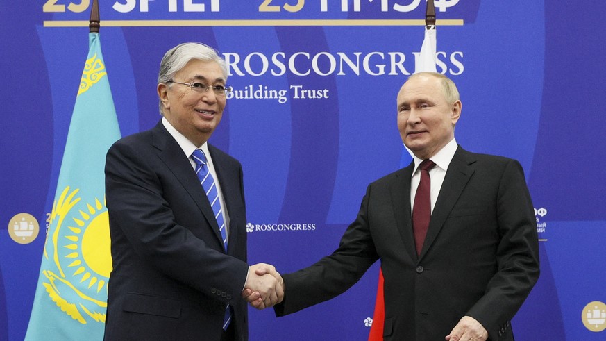 Russian President Vladimir Putin, right, and Kazakhstan&#039;s President Kassym-Jomart Tokayev shake hands prior to their talks on the sidelines of the St. Petersburg International Economic Forum in S ...