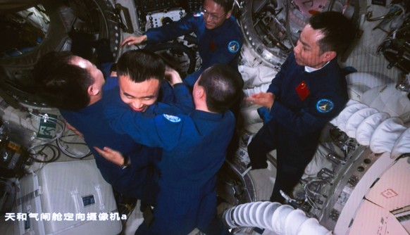 epa10942373 An image captured at the Beijing Aerospace Control Center shows the astronauts of the Shenzhou-16 mission greeting the Shenzhou-17 crew at China&#039;s space station, in Beijing, China, 26 ...