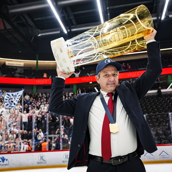 ZSC Lions&#039; Head coach Marco Bayer celebrates with the trophy of Swiss Champion after winning by 2:3 during the fifth leg of the National League Swiss Championship final playoff game between Lausa ...