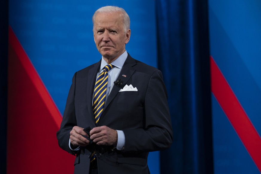 President Joe Biden talks with audience members as he waits for a commercial break to end during a televised town hall event at Pabst Theater, Tuesday, Feb. 16, 2021, in Milwaukee. (AP Photo/Evan Vucc ...