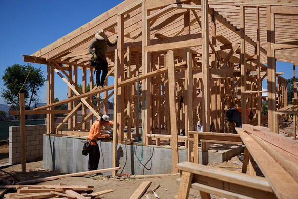 epa12322537 Workers frame a new home as fire recovery efforts continue from the Eaton Fire in Altadena, California, USA, 25 August 2025. In January 2025 the Eaton Fire burned more than 14,000 acres, d ...