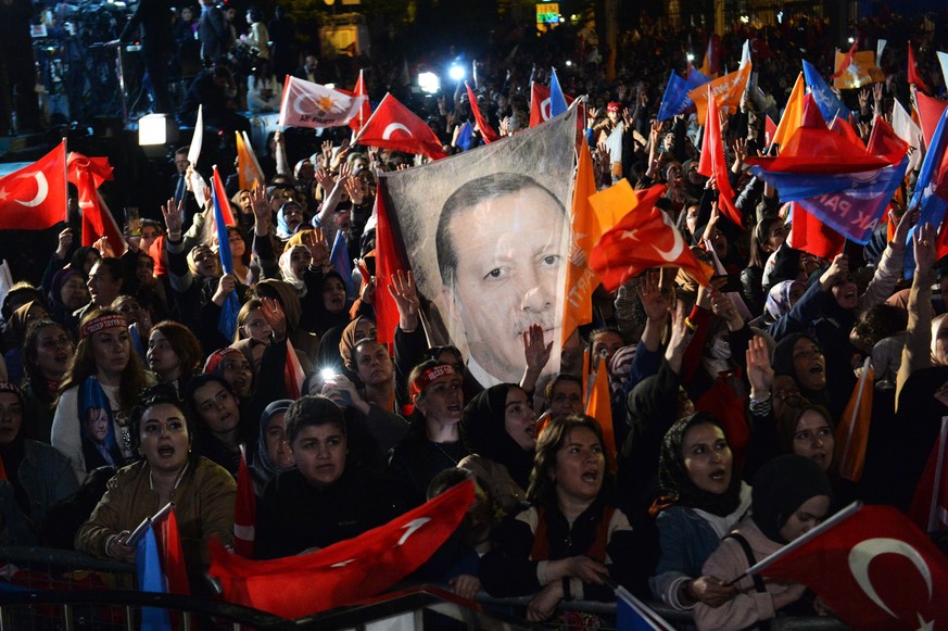 epaselect epa10628789 Supporters wave flags and banners as Turkish President and presidential candidate Recep Tayyip Erdogan makes an address at the Justice and Development Party (AKP) headquarters, i ...