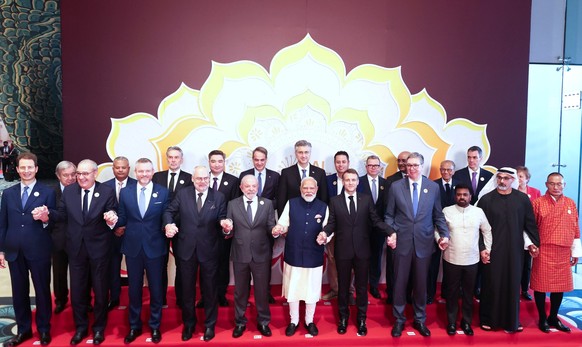 India's Prime Minister Narendra Modi, center, hold hands and poses for photographs with various head of states of participating countries during the AI Summit in New Delhi, India, Thursday, Feb.  ...