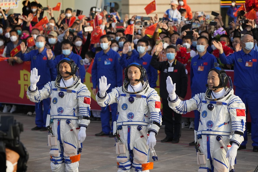 Chinese astronauts for the Shenzhou-16 mission, from left, Gui Haichao, Zhu Yangzhu and Jing Haipeng wave as they attend a send-off ceremony ahead of their manned space mission at the Jiuquan Satellit ...