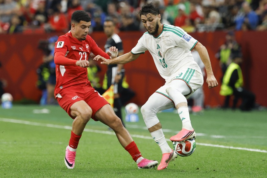 Switzerland's Zeki Amdouni (left) and Algeria's Jaouen Hadjam in action during the World Cup round of 32 soccer match between Switzerland and Algeria at the BC Place stadium in Vancouver, Ca ...