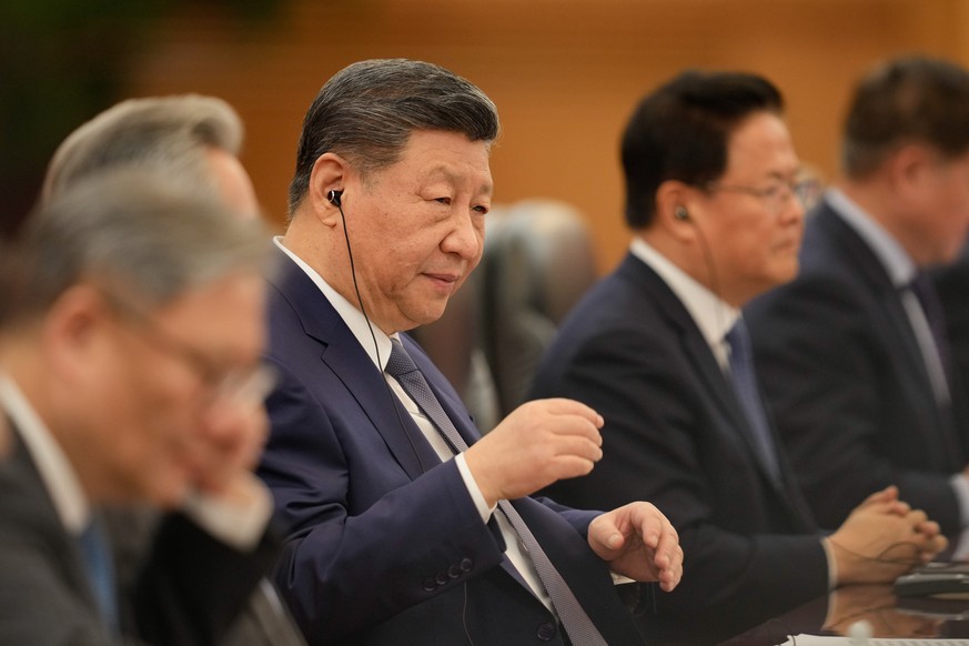 Chinese President Xi Jinping, centre, reacts during a meeting with Canada's Prime Minister Mark Carney (not in the picture), at the Great Hall of the People in Beijing, China, Friday, Jan. 16, 20 ...