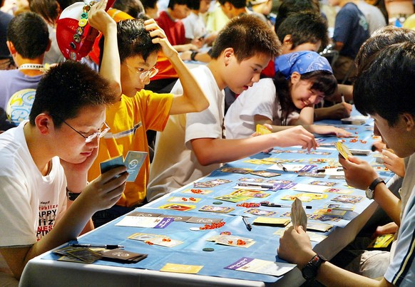 TOK02 - 20020727 - TOKYO, JAPAN : Japanese children play in a Pokemon (Pocket Monster) card game tournament in Tokyo, 27 July 2002 to qualify for the world championship to be held in the US. Some 13 b ...