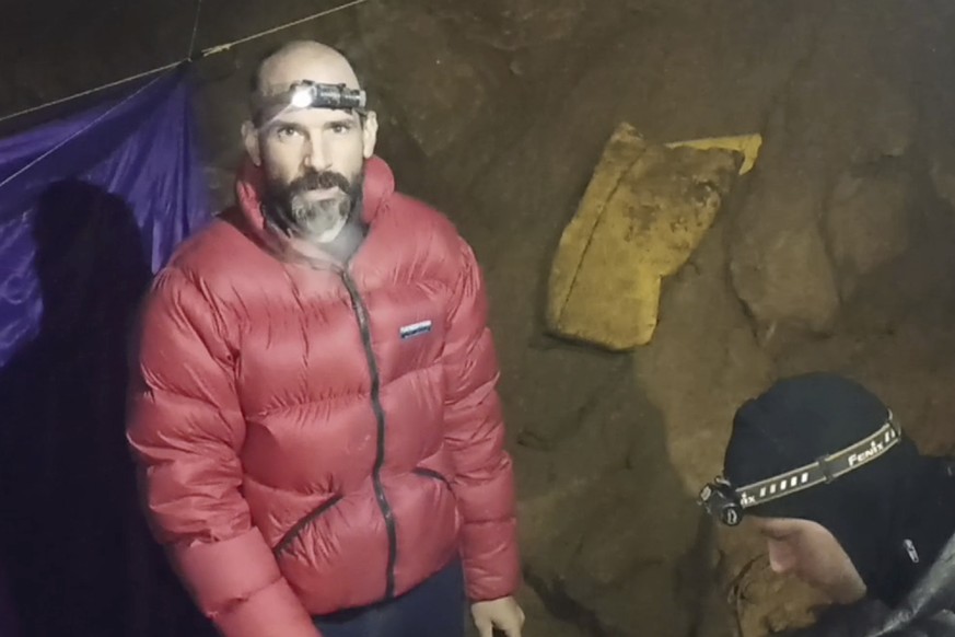 In this screen grab from video, American caver Mark Dickey, 40, talks to camera next to a colleague inside the Morca cave near Anamur, southern Turkey, Thursday, Sept. 7, 2023. Turkish and internation ...