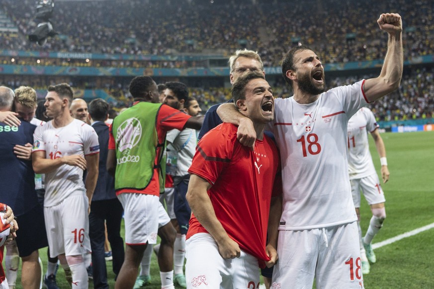 The Swiss team, with from right, Admir Mehmedi and Xherdan Shaqiri, celebrates after winning the Euro 2020 soccer tournament round of 16 match between France and Switzerland at the National Arena stad ...