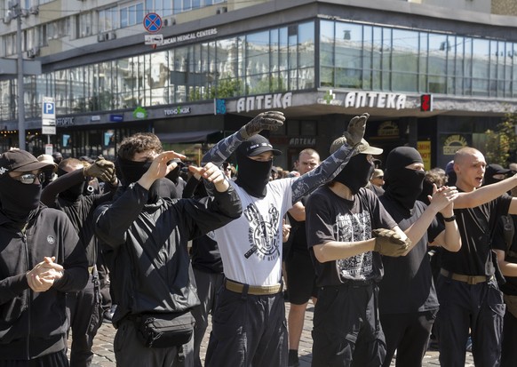 epa13053956 Young activists shout slogans during a rally organized by various Ukrainian nationalist organizations in protest against the annual KyivPride march, in Kyiv, Ukraine, 21 June 2026, amid th ...