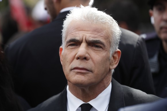 epa10464944 Former Israeli PM Yair Lapid prior to his address to protesters during an anti-government rally next to the Israeli parliament in Jerusalem, 13 February 2023. Israeli activists are protest ...