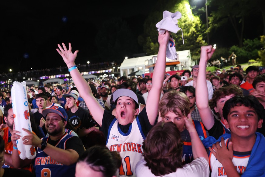 New York Knicks fans react during a watch party inside Central Park for Game 4 of the NBA Finals basketball series between the Knicks and the San Antonio Spurs, Wednesday, June 10, 2026, in New York.  ...