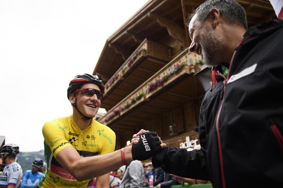 Stefan Kueng from Switzerland of BMC Racing Team, left, shakes hand with tour director Olivier Senn, prior the 5th stage, a 155,7 km race from Gstaad to Leukerbad, Switzerland, at the 82. Tour de Suis ...