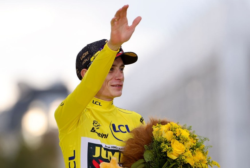 PARIS, FRANCE - JULY 23: Tour de France 2023 winner, yellow jersey Jonas Vingegaard of Denmark and Jumbo - Visma celebrates during the podium ceremony following stage twenty-one, last and final stage  ...