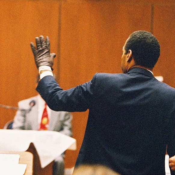 O.J. Simpson shows the judge a leather glove allegedly used in the murders of Nicole Brown Simpson and Ronald Goldman during testimony in Simpson&#039;s murder trial on June 15, 1995 in Los Angeles. ( ...