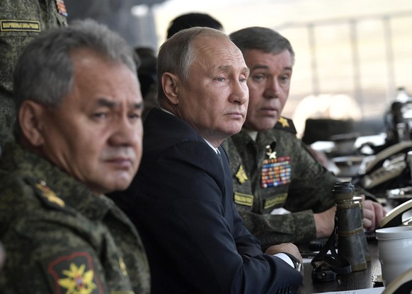 FILE - Russian President Vladimir Putin, center, Russian Defense Minister Sergei Shoigu, left, and Head of the General Staff of the Armed Forces of Russia and First Deputy Defense Minister Valery Gera ...