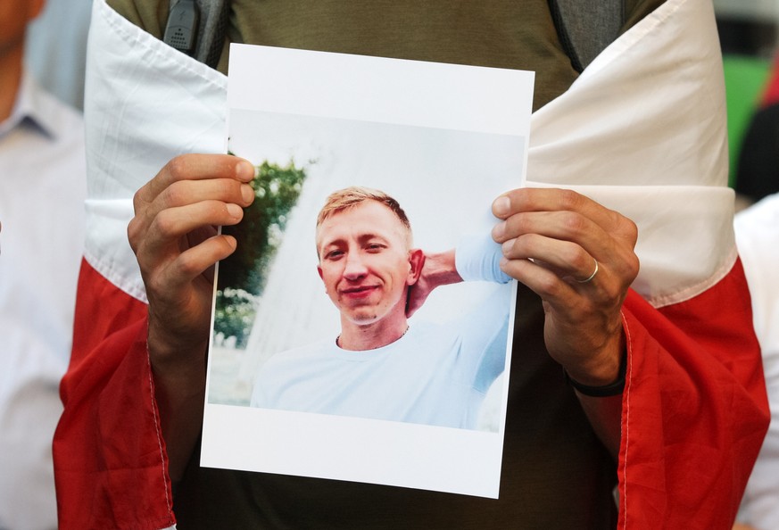 epa09392422 A man holds a portrait of Vitaly Shishov during a rally of Belarusians living in Ukraine and Ukrainian activists in memory of dead Belarusian activist Vitaly Shishov in front of the Belaru ...