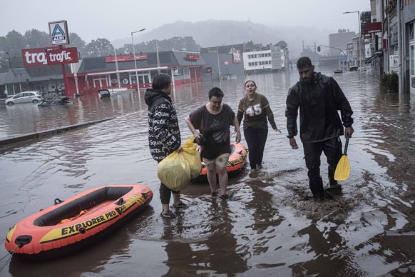 Residents use rubber rafts to evacuate after the Meuse River broke its banks during heavy flooding in Liege, Belgium, Thursday, July 15, 2021. Heavy rainfall is causing flooding in several provinces i ...