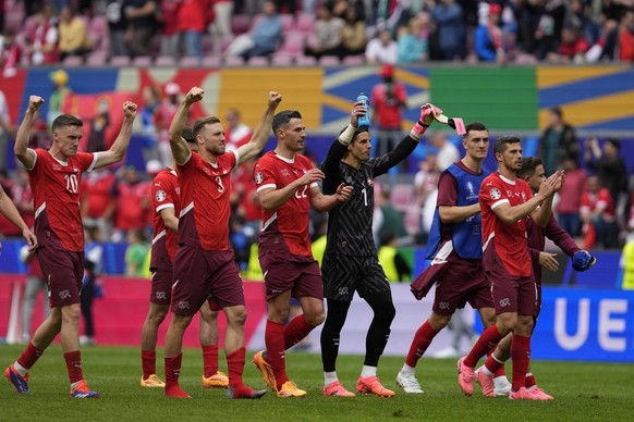 Swiss team members celebrate after a Group A match between Hungary and Switzerland at the Euro 2024 soccer tournament in Cologne, Germany, Saturday, June 15, 2024. (AP Photo/Darko Vojinovic)