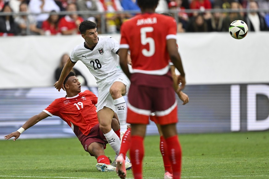 Switzerland&#039;s Dan Ndoye, and Austria&#039;s Flavius David Daniliuc, in action during an international friendly soccer match between Switzerland and Austria at the kybunpark stadium in St. Gallen, ...