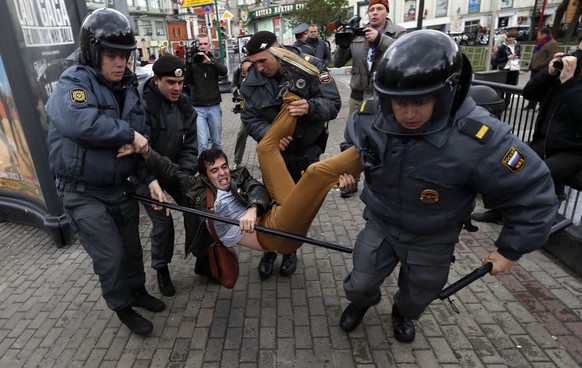 Police officers detain political activist Roman Dobrokhotov during the unauthorized meeting to mark Russian President Vladimir Putin&amp;#039;s birthday in Moscow, Sunday Oct. 7, 2012. Vladimir Putin  ...