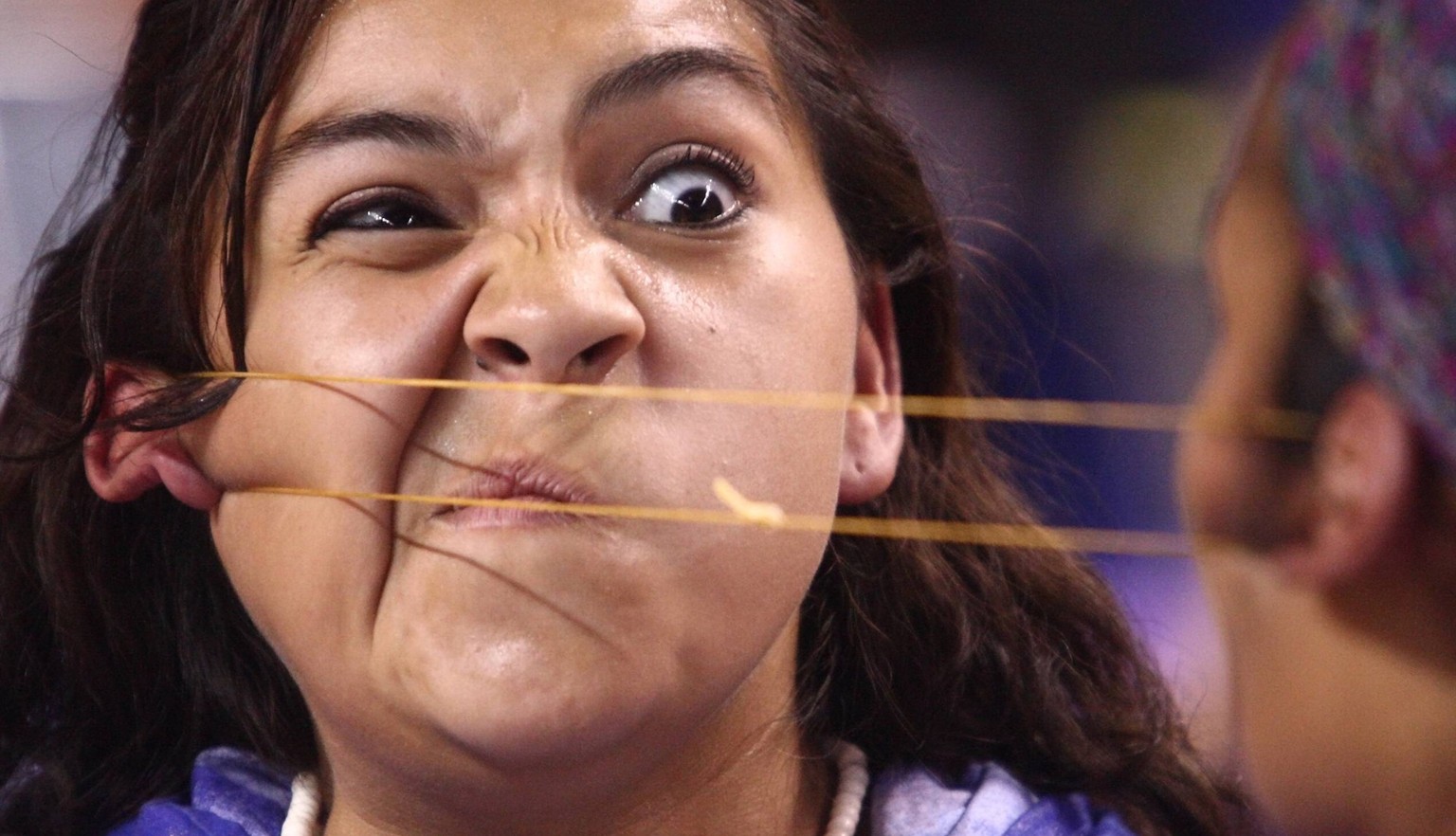 July 23, 2010 - Fairbanks, AK, U.S. - Vanessa Tahbone of Nome grimaces while competing against Nicole Colbert of Napakiak during the Ear Pull event at the 49th Annual World Eskimo-Indian Olympics 2010 ...