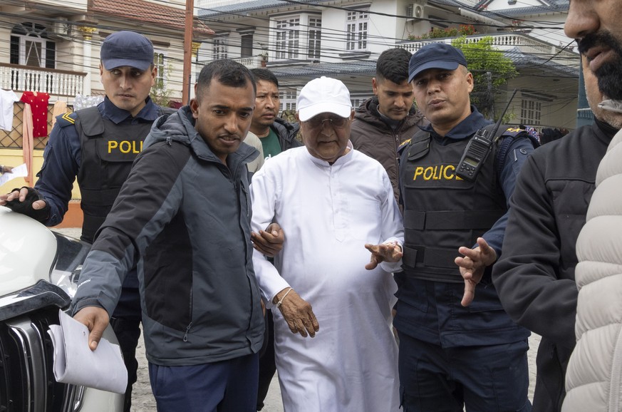 epa12855860 Nepalese police escort former prime minister KP Sharma Oli (C) for a medical check-up following his arrest in Kathmandu, Nepal, 28 March 2026. Former PM Oli was arrested over his alleged i ...
