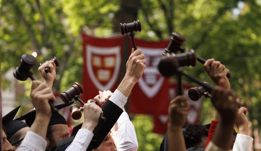epa10653437 Graduate from the Harvard School of Law wave small gavels as they are bestowed their degrees, during the 372nd Commencement ceremonies at Harvard University in Cambridge, Massachusetts, US ...