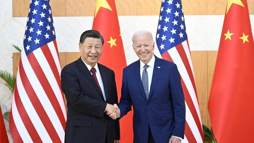 epa10305493 Chinese President Xi Jinping (L) greets his US counterpart Joe Biden before their meeting, one day ahead of the G20 Summit in Bali, Indonesia, 14 November 2022. The 17th Group of Twenty (G ...