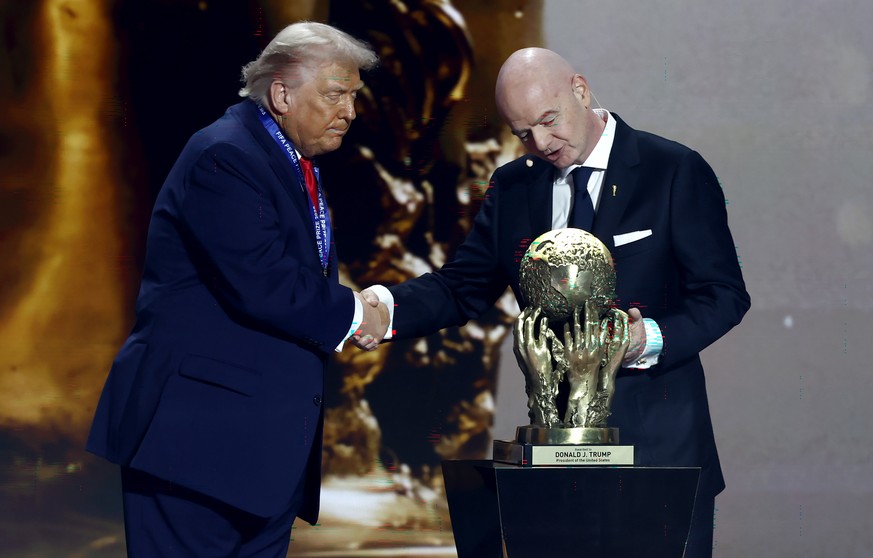 epaselect epa12572616 US President Donald Trump (L) receives the FIFA Peace Prize from FIFA President Giovanni Infantino during the FIFA World Cup 2026 Final Draw at the Kennedy Center in Washington D ...