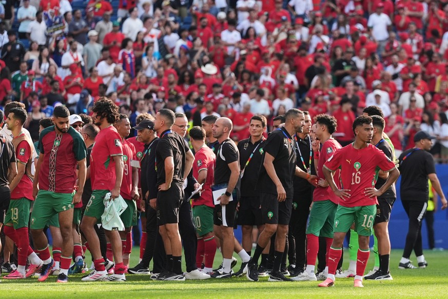 Morocco team and staff walk off the pitch after the World Cup quarterfinal soccer match between France and Morocco in Foxborough, Mass., near Boston, Thursday, July 9, 2026. (AP Photo/Stephanie Scarbr ...