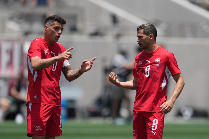 Switzerland midfielder Granit Xhaka, left, talks with midfielder Remo Freuler during the first half of an international friendly soccer game against Australia Saturday, June 6, 2026, in San Diego. (AP ...
