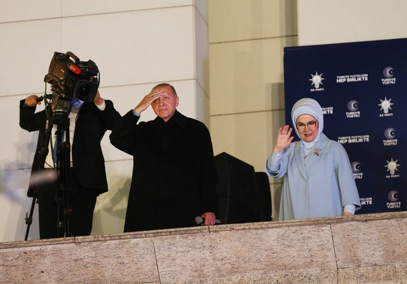 epa10628786 Turkish President and presidential candidate Recep Tayyip Erdogan (C) waves to supporters at the Justice and Development Party (AKP) headquarters, in Ankara, Turkey, 15 May 2023, the day a ...