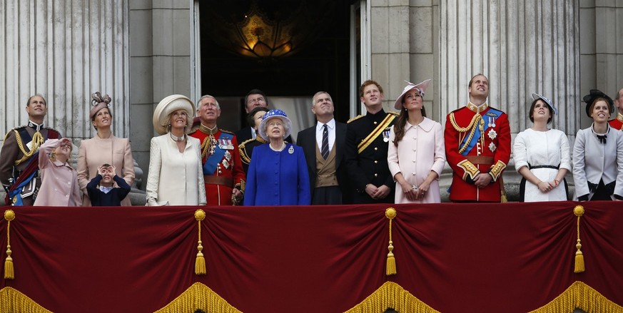 Britain&#039;s Queen Elizabeth II, centre, surrounded by members of her family, watch a Royal Air Force fly past, on the balcony of Buckingham Palace, during the Trooping The Colour parade, in London, ...