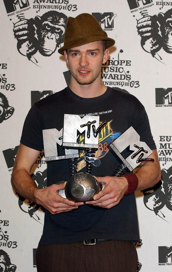 Singer Justin Timberlake with his awards for Best Male, Best Pop Act and Best Album poses for photos backstage during the MTV Europe Music Awards 2003 at Western Harbour in Leith, Edinburgh, late Thur ...