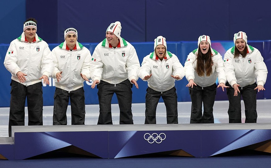 MILAN, ITALY - FEBRUARY 10: Gold medalists Elisa Confortola, Arianna Fontana, Thomas Nadalini, Pietro Sighel, Chiara Betti and Luca Spechenhauser of Team Italy celebrate on the podium during the medal ...
