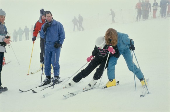 British Royals Prince Andrew, Duke of York, partially obscured behind his brother Charles, Prince of Wales, whose wife, Diana, Princess of Wales, is supported by Sarah, Duchess of York on a ski slope  ...
