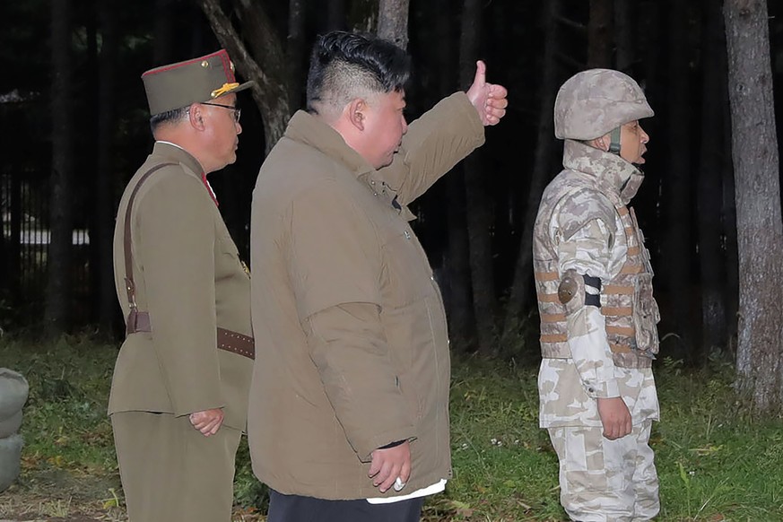 In this photo provided on Oct. 10, 2022, by the North Korean government, North Korean leader Kim Jong Un, center, inspects what it says a ballistic missile test held during Sept. 25 and Oct. 9, 2022 a ...