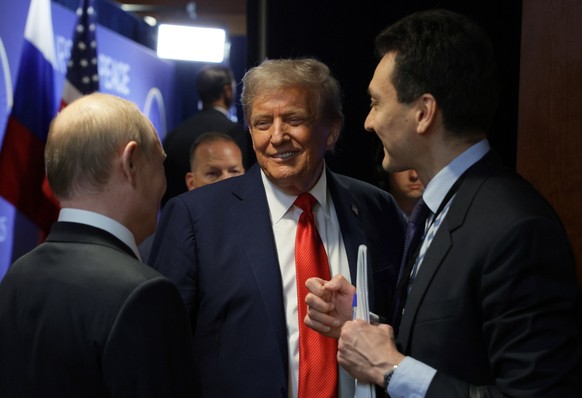 epa12303723 US President Donald Trump (C) and Russian President Vladimir Putin (L) speak before a joint news conference following their meeting at Joint Base Elmendorf-Richardson in Anchorage, Alaska, ...