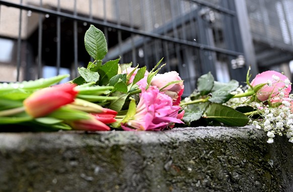 epa10513536 Flowers lay outside the crime scene a day after a deadly shooting in Hamburg, Germany, 10 March 2023. According to Hamburg authorities, at least eight people died, including the suspected  ...