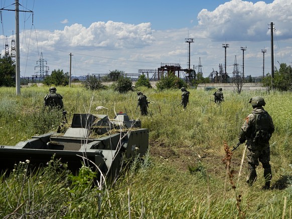Russian mine clearing experts work to find and defuse mines along the high voltage line in Mariupol, on the territory which is under the Government of the Donetsk People&#039;s Republic control, easte ...