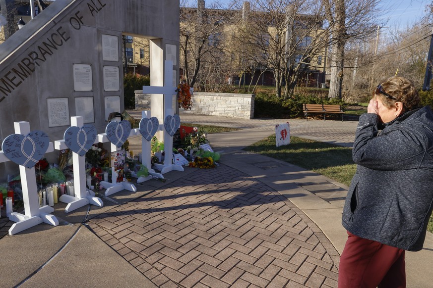 A woman who did not want to be identified cries at a memorial in Waukesha, Wis., Tuesday, Nov. 23, 2021. She had a daughter who marched in the parade and witnessed the incident. On Sunday an SUV plowe ...