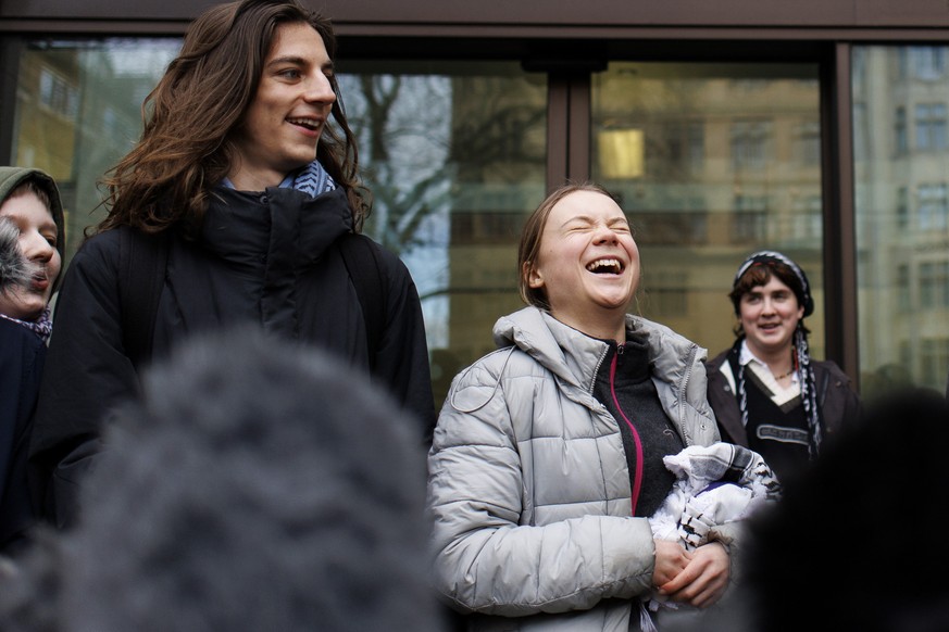epa11120632 Swedish environmental activist Greta Thunberg (C) speaks to the press as she arrives at Westminster Magistrates Court during the lunch break in London, Britain, 02 February 2024. Thunberg  ...