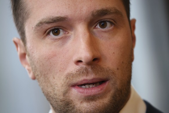 National Rally president Jordan Bardella answers reporters after French police raided the Paris headquarters of the far-right party, as part of a sweeping campaign finance inquiry, Wednesday July 9, 2 ...