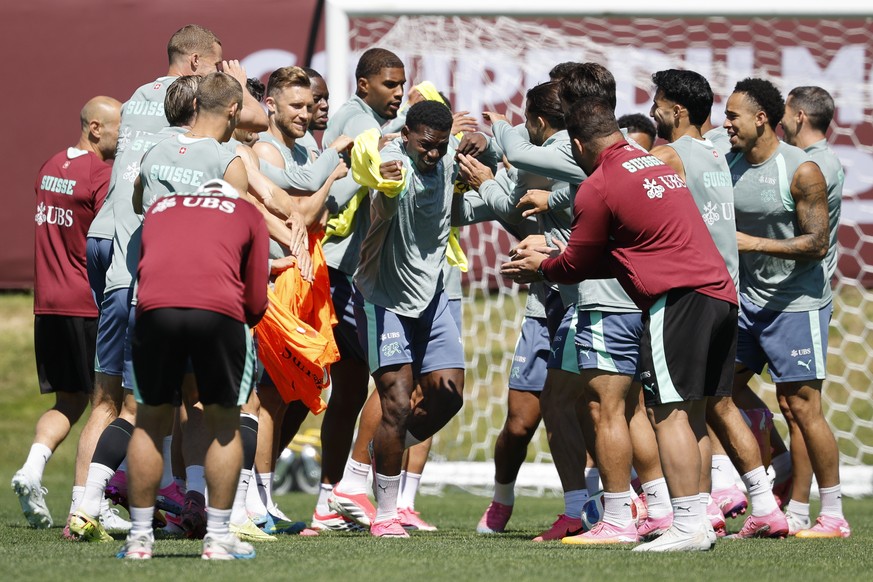 epa13089609 Switzerland's Breel Embolo (C) gets slapped by his teammates during a Switzerland training session at the National Soccer Development Center in Vancouver, Canada, 05 July 2026, during ...