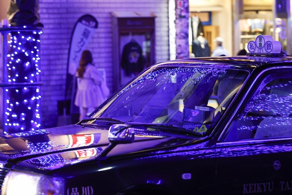 A taxi driver drives under blue LED lights displayed along the streets of the Shibuya area as part of the Blue Cave Illumination 2024 event on December 6, 2024, in Tokyo, Japan. Thousands of blue LED  ...